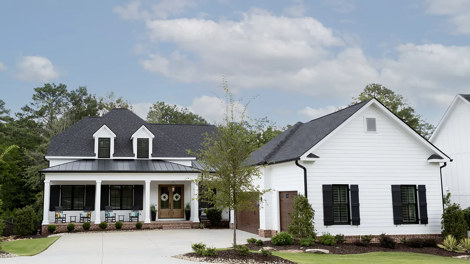 White farmhouse with a mown front lawn and a clean walk